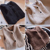 A collection of three cozy kids' lamb wool vests in black, cream, and brown.