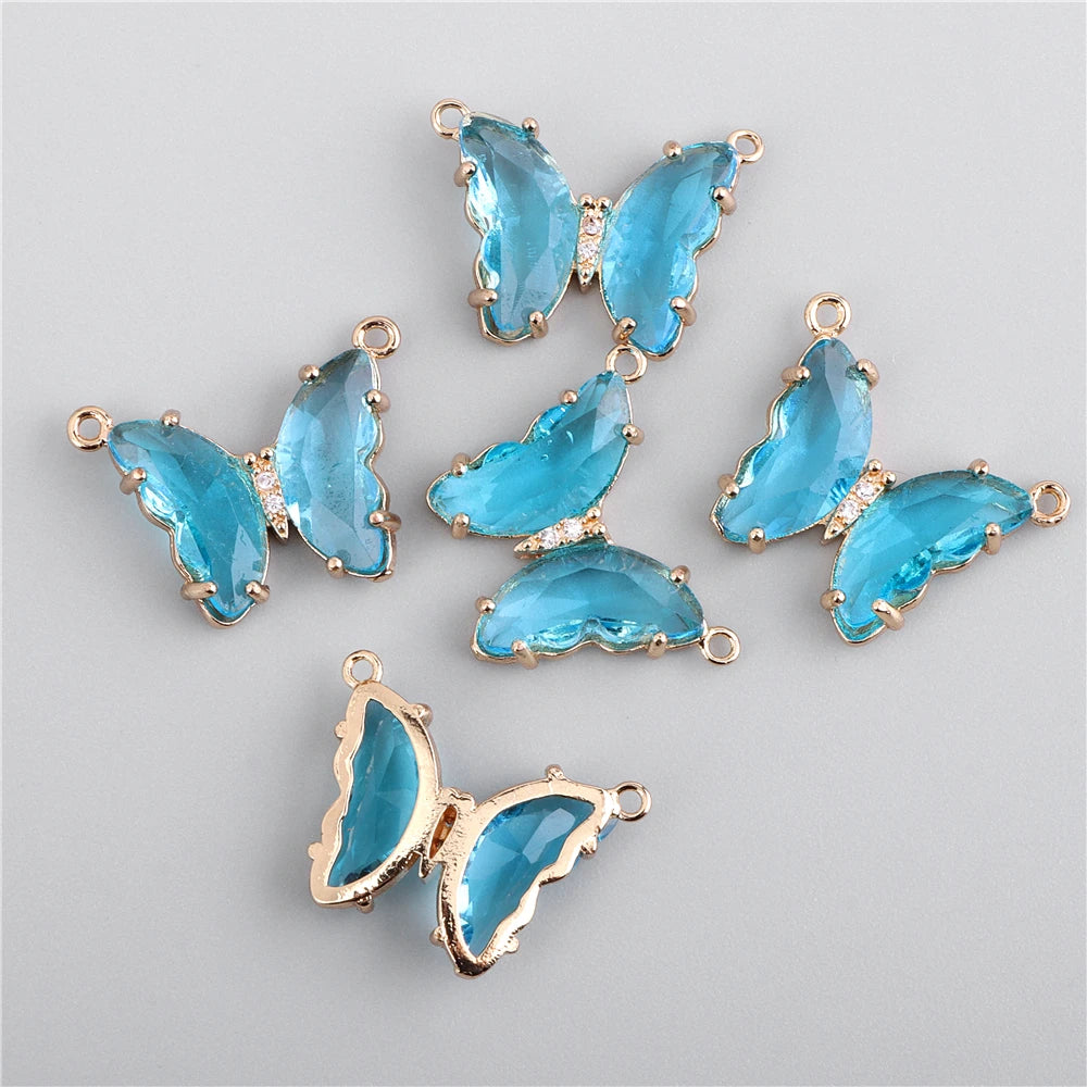 A collection of sparkling blue crystal butterfly charm beads for jewelry making.