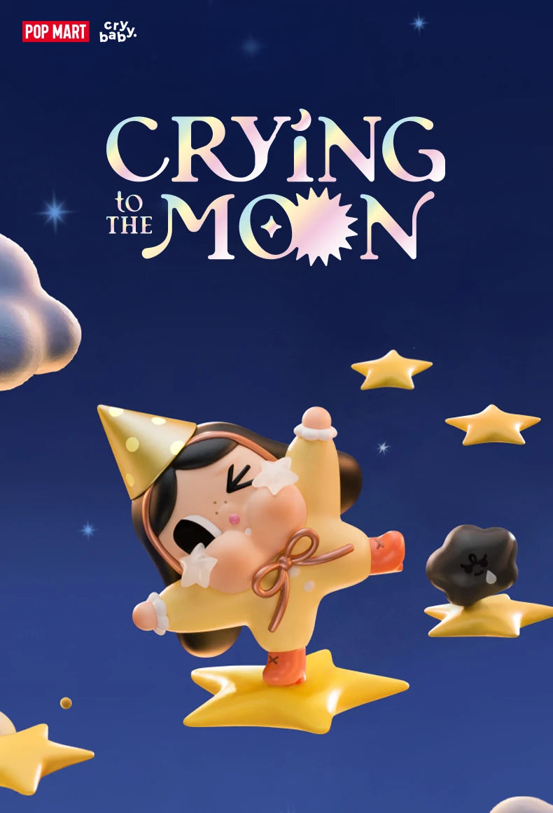 A yellow collectible figurine of a crying baby with dark hair and a bow, surrounded by gold stars against a dark blue backgro