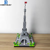 A miniature model of the Eiffel Tower built from gray LEGO-style blocks on a wooden surface.
