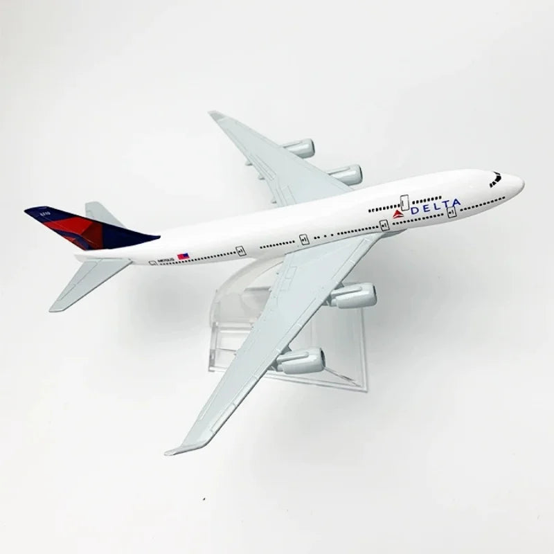 A white Delta Airlines Boeing 747 diecast model airplane in flight.