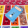 A box of Circus Flohcatl cards lying on a grid of game cards.
