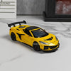 A yellow 1:32 scale diecast supercar model with pull-back action displayed on a white marble surface.