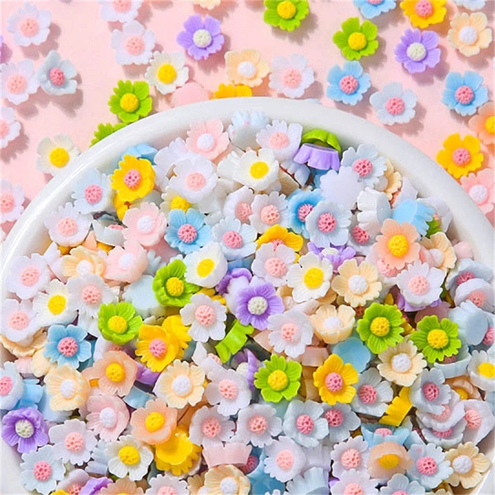 A bowl filled with assorted pastel colored resin flatbacks for DIY crafts and jewelry making