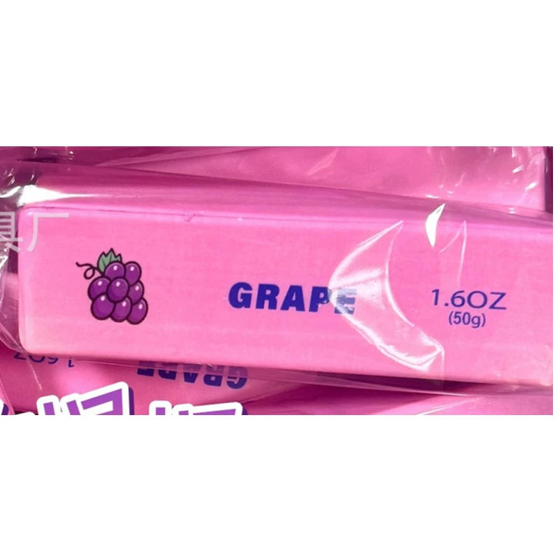 A pink squishy stress relief fidget toy labeled GRAPE 1.6oz (50g) with a purple grape graphic.