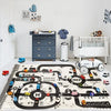 A play mat featuring a detailed city road map layout for children to use in imaginative play.