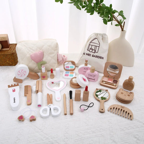 A collection of kids pretend makeup and dress-up toys including brushes, mirrors, and cosmetic items displayed on a white clo