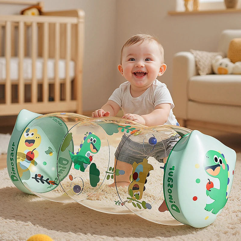 A clear silicone dinosaur crawling roller toy with green and yellow dinosaurs is shown on a light-colored rug.