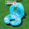 A blue inflatable pool lounger for two with a sun canopy and backrest resting on green grass.