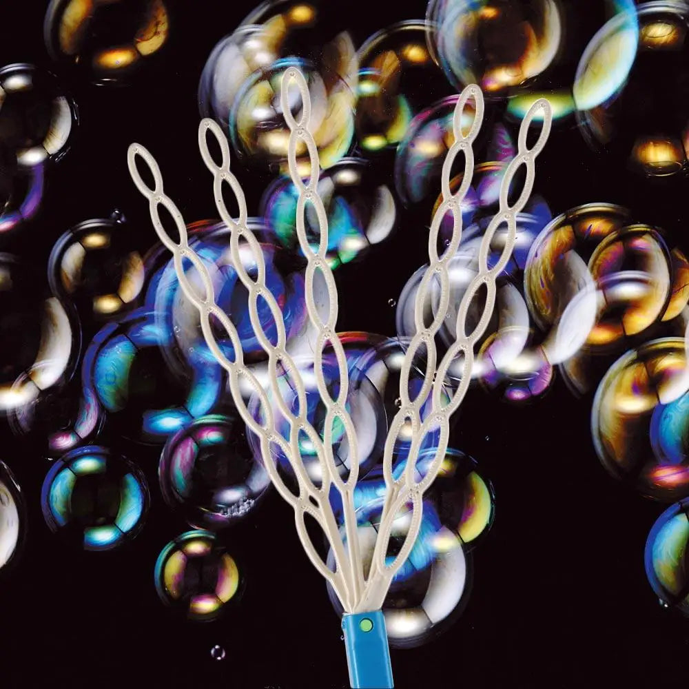 A white 32-hole smiling face bubble wand with a blue handle surrounded by iridescent soap bubbles against a black background.