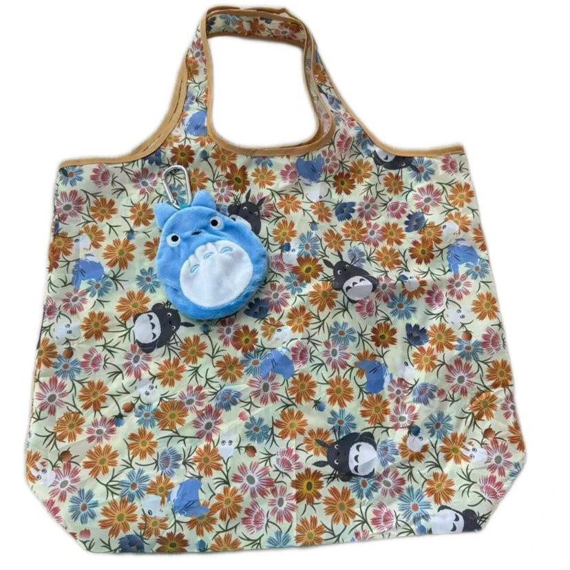 A soft stuffed animal of a pygmy hippo in blue and white, displayed on a floral patterned fabric bag.