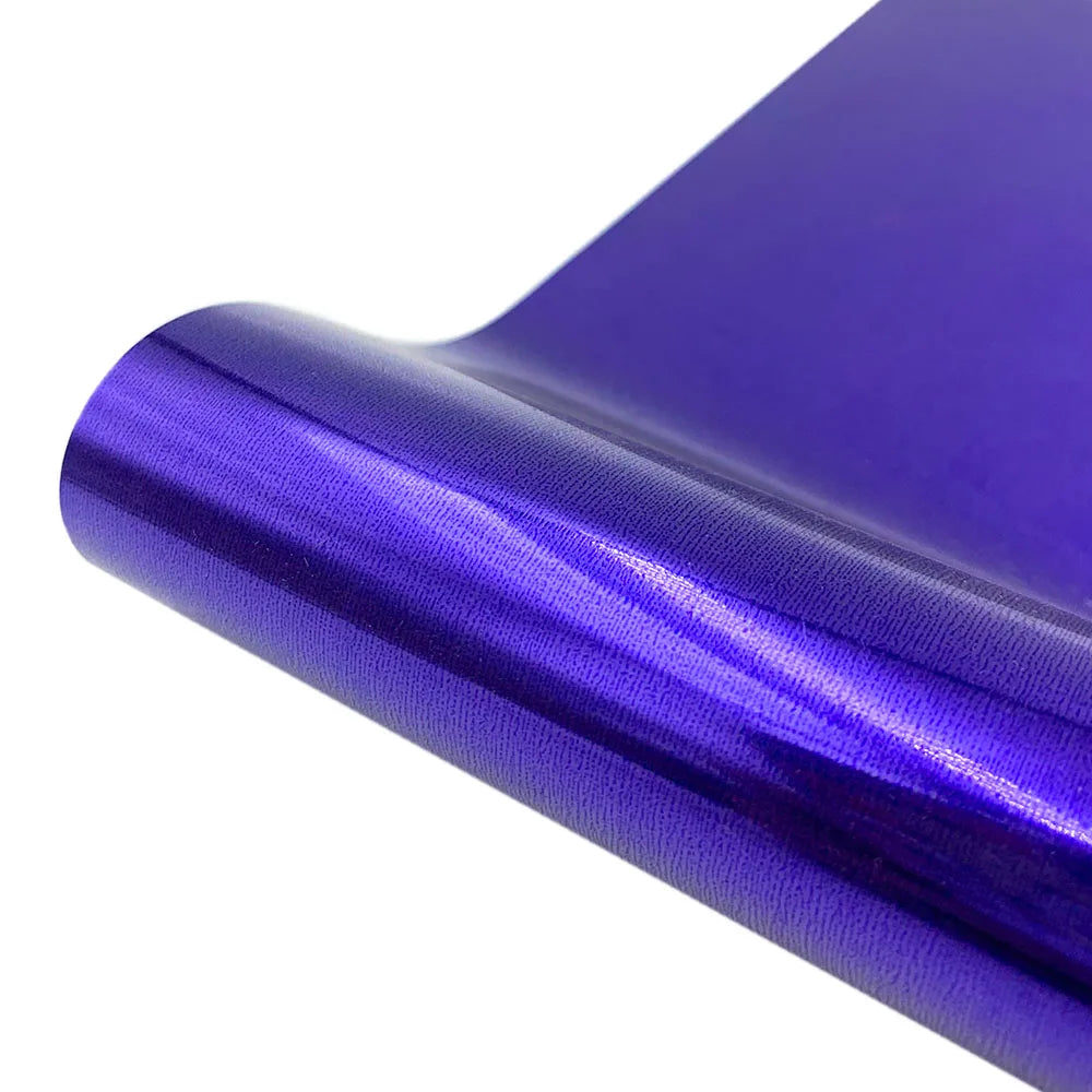 Purple holographic heat transfer vinyl rolled up, showing a shiny iridescent texture.