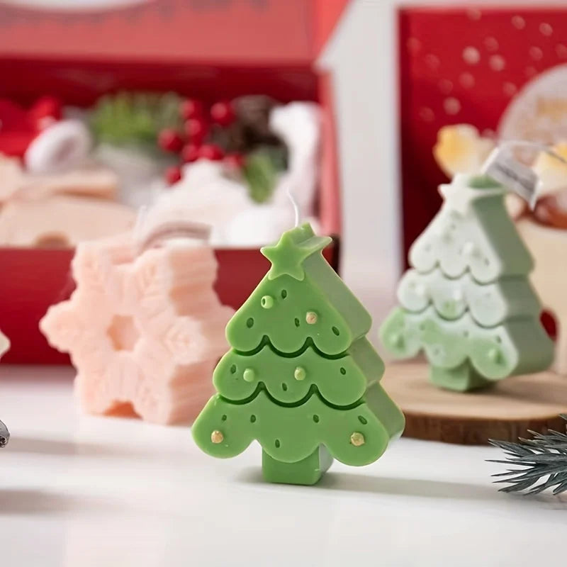 A set of festive silicone Christmas tree and snowflake cookie and candle molds in green and pink colors.