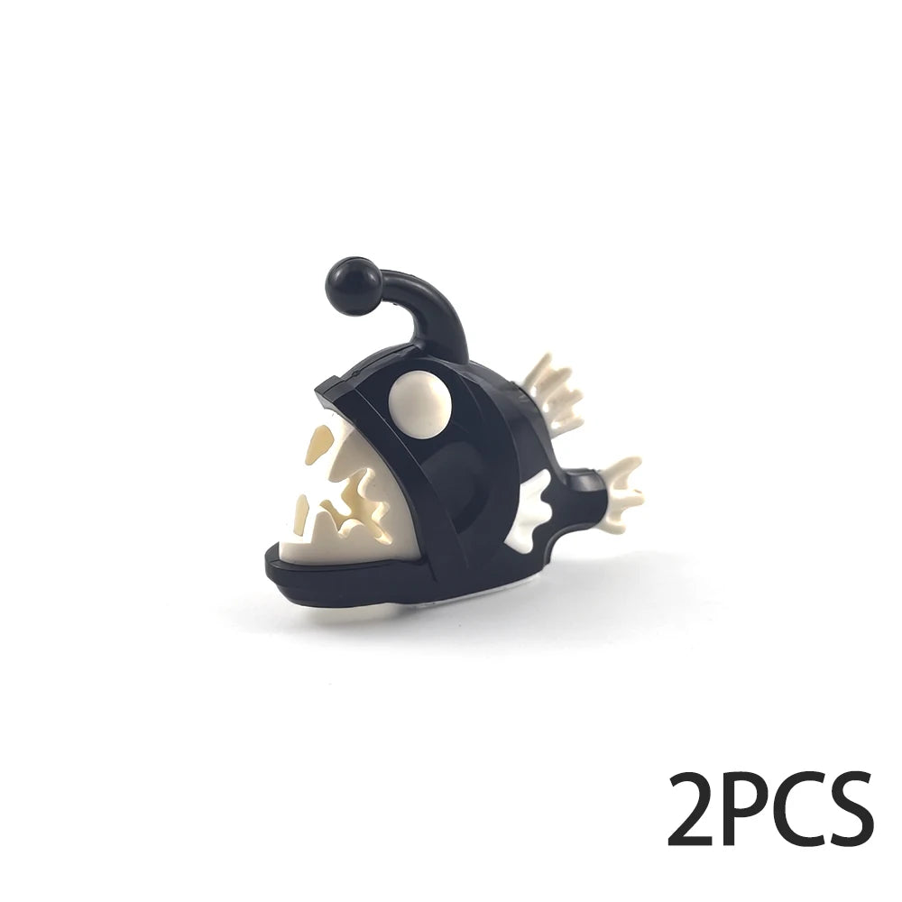 A black plastic ocean animal building block featuring a white snout and ear, with a small protrusion on top.