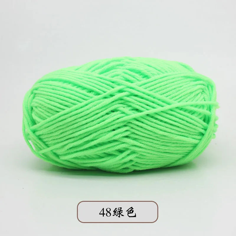 A ball of bright lime green pre-dyed milk cotton yarn for knitting and crochet.