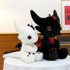 A black Toothless dragon plush toy with red accents is displayed on a white cloth.