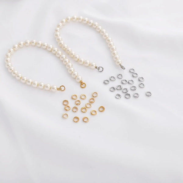 A collection of pearl strings and silver double hole linking rings for jewelry making