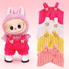 A pink and red Labubu plush doll wearing colorful strap pants.