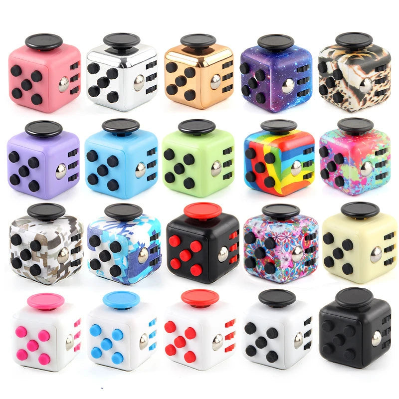 A collection of colorful fidget cubes with magnetic buttons and rotating joysticks in various patterns and colors.
