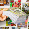 A hand holds a stack of retro Japanese style sticker book set for scrapbooking and journaling