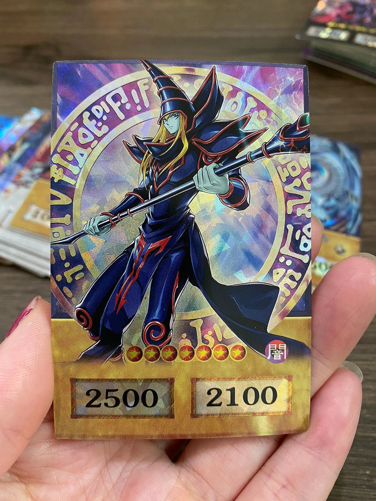 A Yu-Gi-Oh! anime style card featuring a wizard character with a staff and magical effects, displayed in a hand.