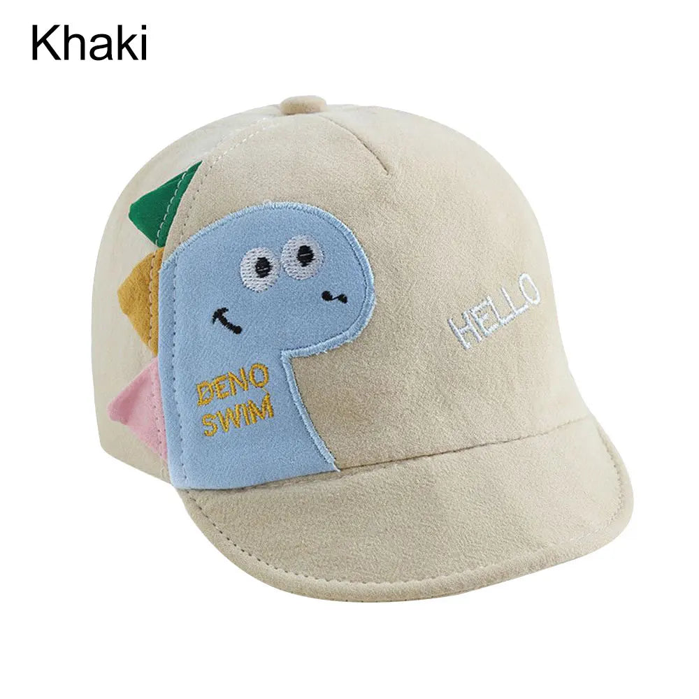 A beige baby cotton baseball cap featuring a blue dinosaur design and cute rabbit ears.