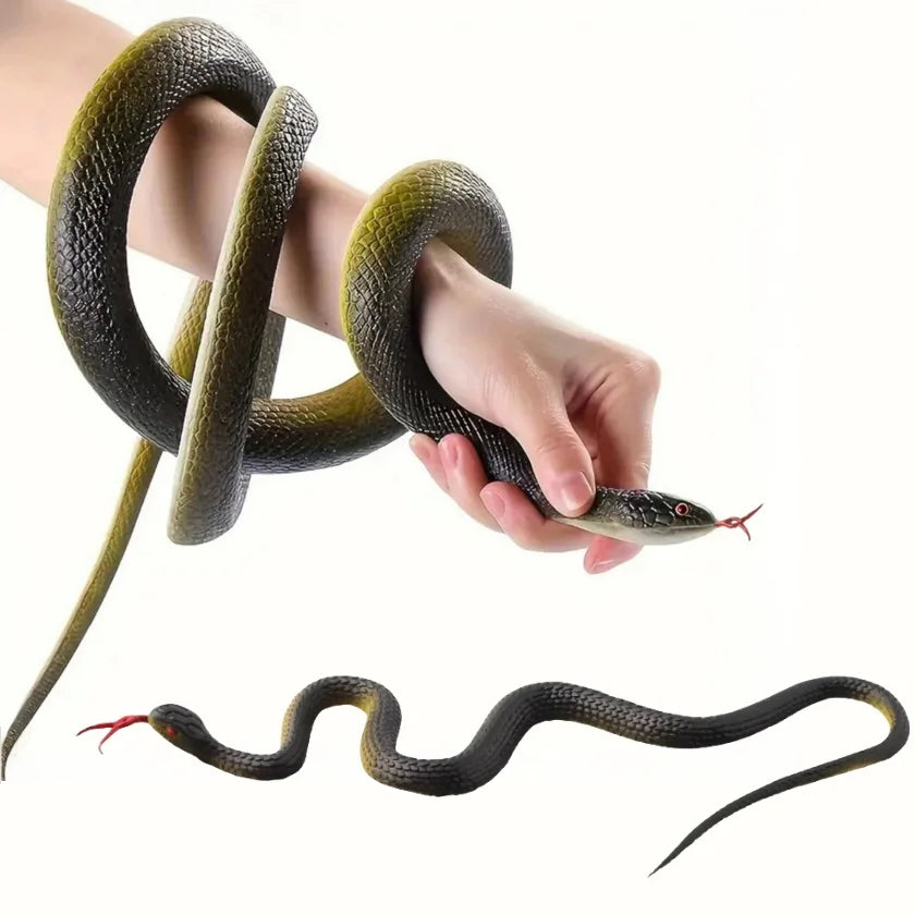 A hand is holding a realistic green rubber snake, coiled and extended, against a white background.