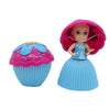 A doll dressed as a princess with pink hair and a blue dress, standing next to a cupcake-shaped accessory.