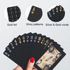 A stack of black poker playing cards featuring gold foil, shiny patterns, and silver and gold words.