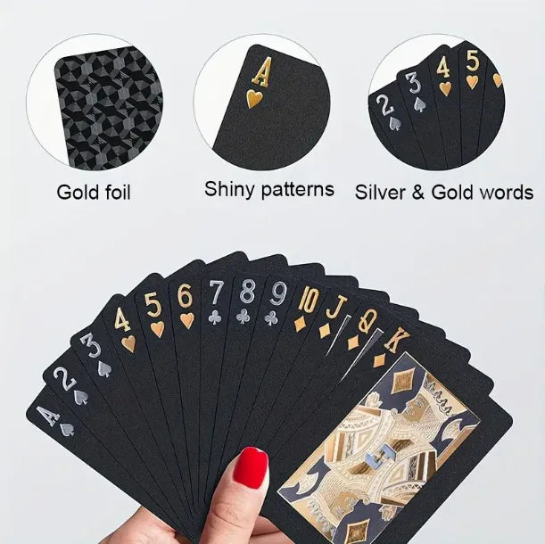 A stack of black poker playing cards featuring gold foil, shiny patterns, and silver and gold words.