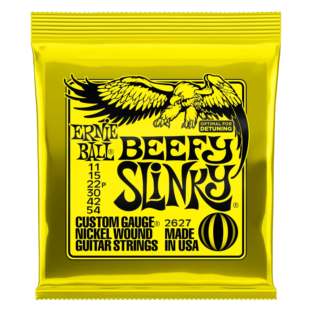 A yellow foil package of Ernie Ball Beefy Slinky nickel wound electric guitar strings.
