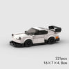 A white and black classic rally car building block set with orange accents.