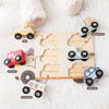A wooden puzzle featuring various emergency vehicles like taxis, fire trucks, ambulances, and police cars for toddlers.