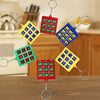 A set of five mini tic tac toe puzzles attached to keychains in red, green, and yellow.