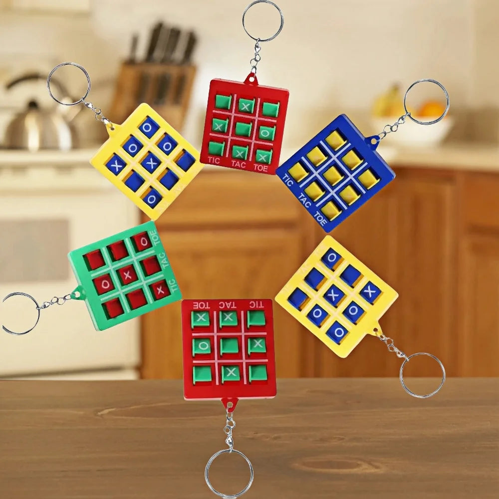A set of five mini tic tac toe puzzles attached to keychains in red, green, and yellow.