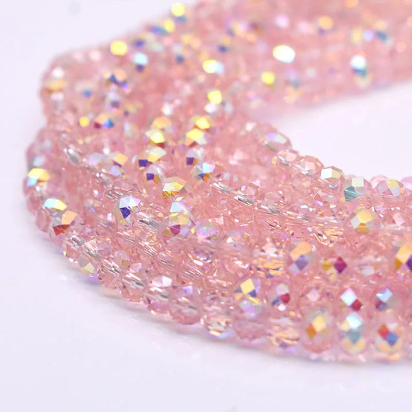 Pink crystal glass beads for jewelry making arranged in a flexible strand.