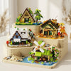 A wooden building block set featuring a forest cabin, greenhouse, and windmill structures.