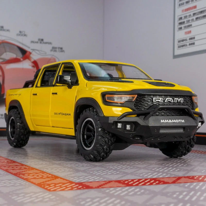 Yellow RAM TRX diecast pickup truck model displayed on a showroom floor.