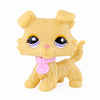 A small, yellow miniature pet animal figure with large eyes and a pink collar.