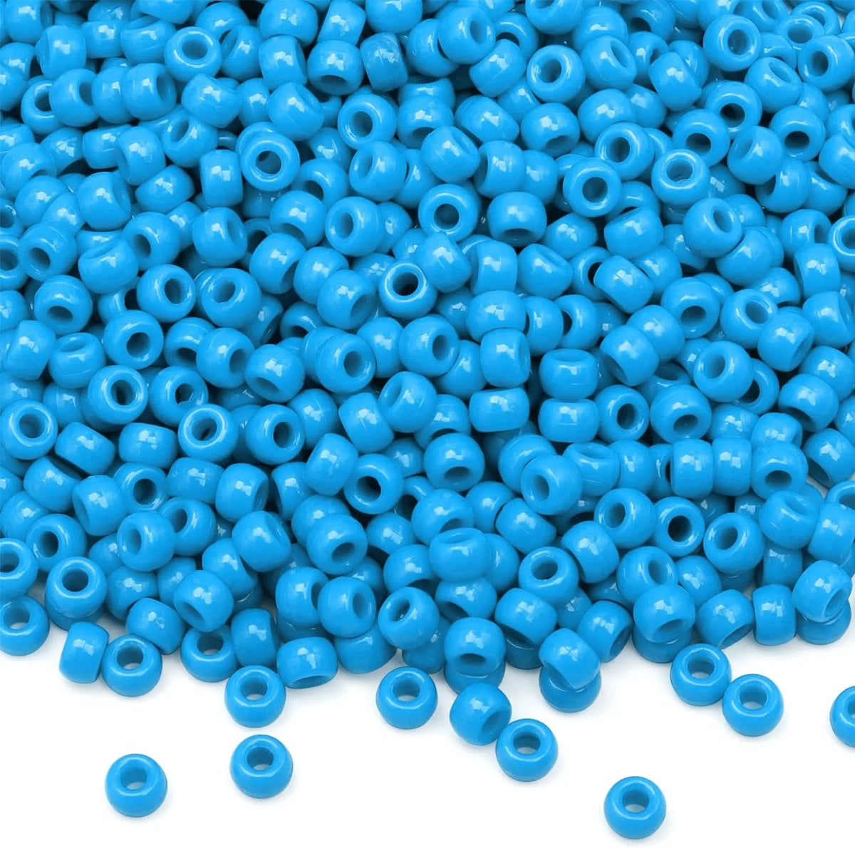 A pile of small, bright blue pony beads for jewelry making