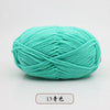 A ball of teal pre-dyed milk cotton yarn used for knitting and crochet projects.