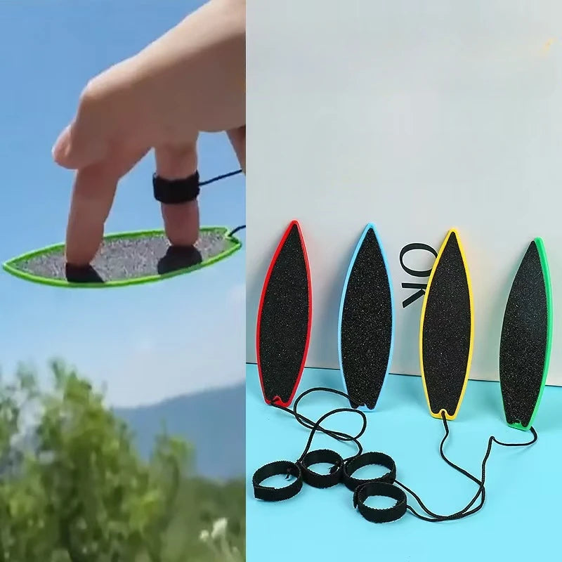 A hand is shown holding a green mini surfboard skateboard toy with black and yellow fins, next to several black rubber rings.