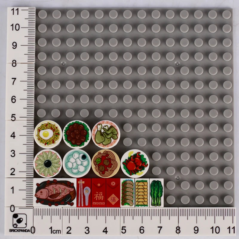 A grid of small gray building blocks with various food items like pizza, cake, and condiment bricks.