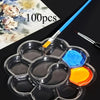 A clear silicone paint palette with multiple wells holds various colorful paints and a paintbrush, set against a dark backgro