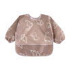 A light beige full-sleeve waterproof baby bib featuring a pattern of cute cartoon animals.