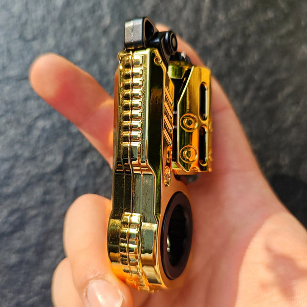 A hand holds a gold-colored mechanical fidget slider and spinner toy.