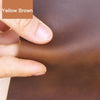 A hand is showing the texture and color of brown leather, labeled Yellow Brown, for crafting.