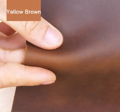 A hand is showing the texture and color of brown leather, labeled Yellow Brown, for crafting.