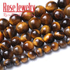 A close-up of natural yellow tiger eye stone beads used for jewelry making.