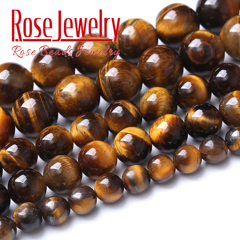 A close-up of natural yellow tiger eye stone beads used for jewelry making.